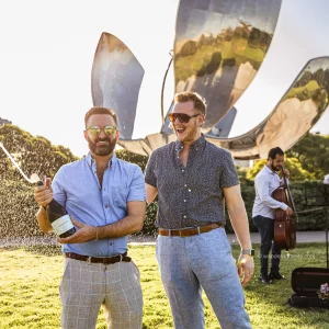 Gay surprise proposal under a magic golden hour in the Floralis genérica park Buenos Aires Argentina