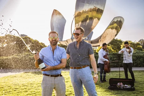 Gay surprise proposal under a magic golden hour in the Floralis genérica park Buenos Aires Argentina